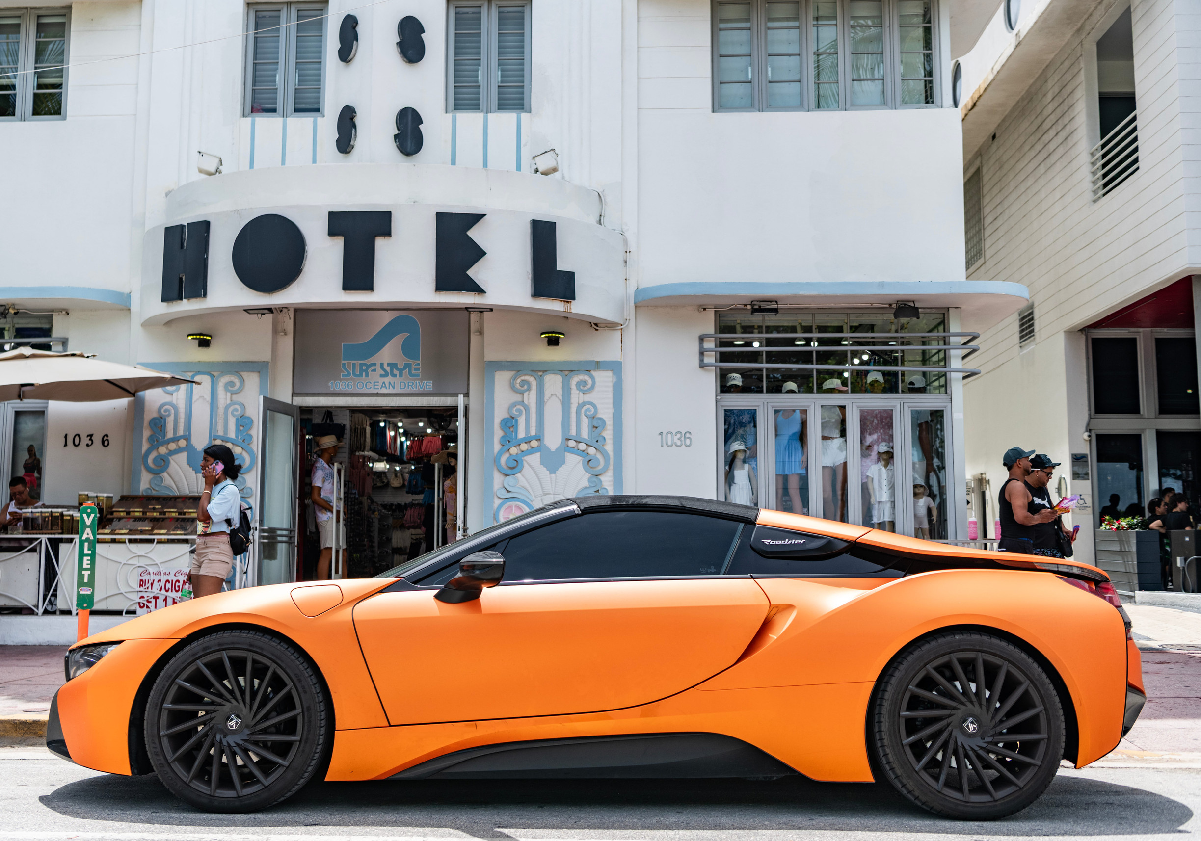 Miami, Florida, USA - July 12, 2025: Car BMW i8 roadster parked outdoor. Orange color sedan car, side view. BMW i8 Roadster sport car convertible. Luxury roadster car BMW i8