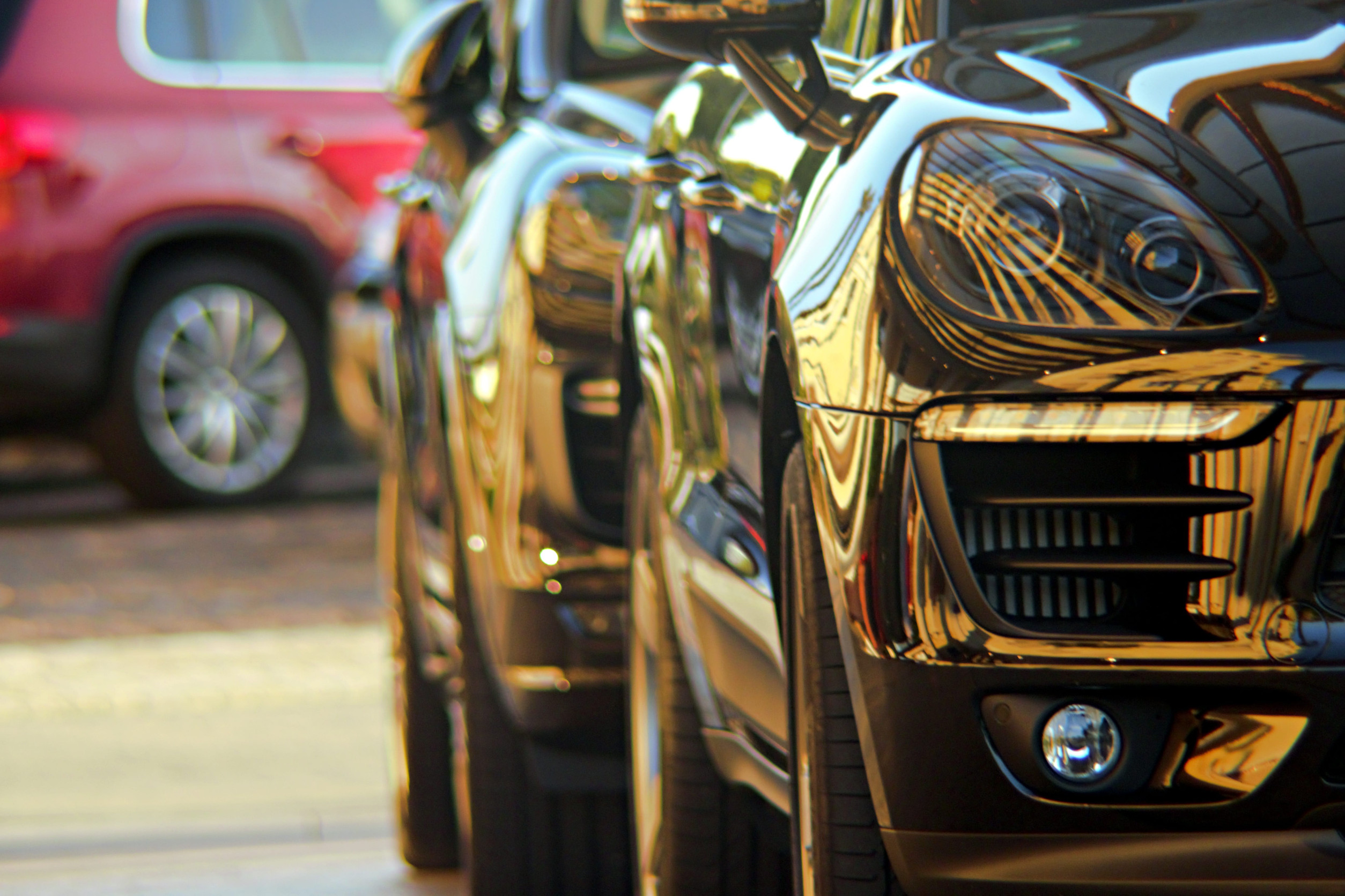Two luxury SUV parked in line horizontal